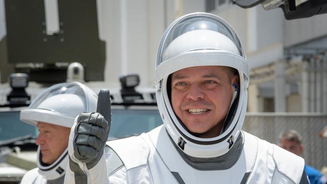 NASA astronauts Robert Behnken (R) and Douglas Hurley, wearing SpaceX spacesuits, are seen as they depart the Neil A. Armstrong Operations and Checkout Building for Launch Complex 39A to board the SpaceX Crew Dragon spacecraft.