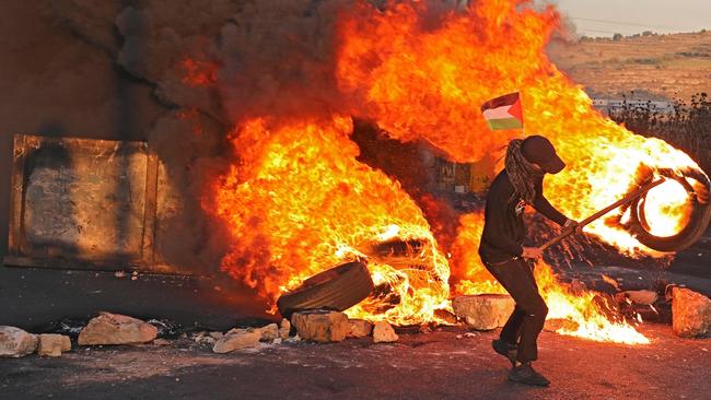 Palestinian demonstrators burn tires during a protest against the tension in Jerusalem and the Israeli-Gaza fighting. Picture: AFP