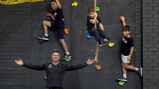 Coach Paul Lyons at the gym in Essendon Daniel, 10, Julian, 8 and Jude, 4, Saccuzzo, in 2018. Picture: Luis Enrique Ascui