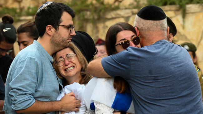 The mother, and immediate family of Eli Ghnassia, 23, who was killed in a battle with Hamas militants near the Israeli border with the Gaza Strip, grieve during his funeral. Picture: Getty Images