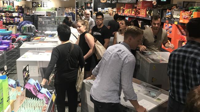 Shoppers hustle in a bid to get their hands on the eight rocking chairs available at the Chatswood store.