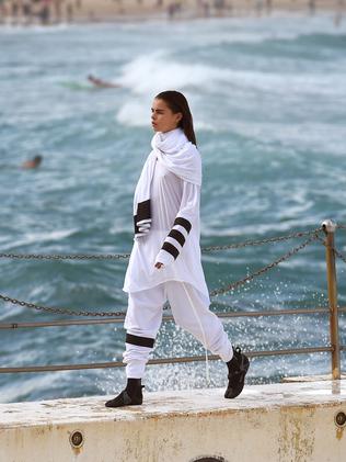 A model parades an outfit by fashion label Tenpieces at Bondi Beach during Fashion Week Australia in Sydney on April 16, 2015. AFP PHOTO / William WEST