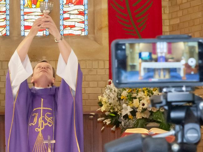 images of Fr Greg Morgan live streaming Mass at St Charles Borromeo Catholic Church, Ryde. I've included vertical & horizontal images or you can just crop as required. Caption must be attributed exactly as follows: Giovanni Portelli / Catholic Archdiocese of Sydney.