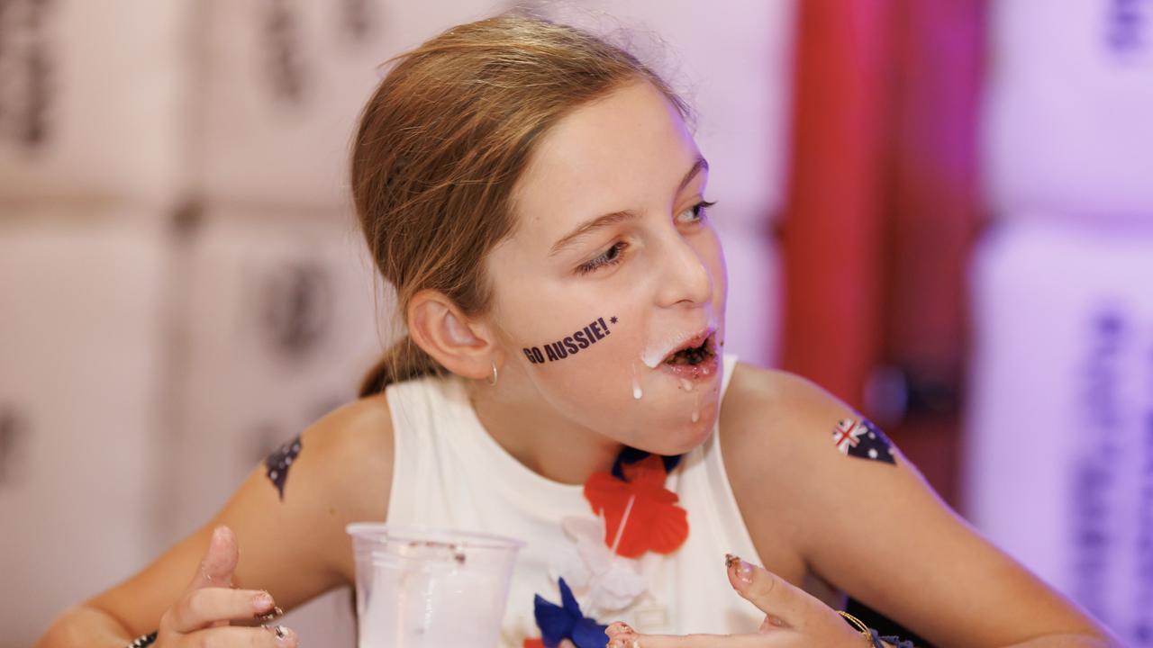 Action from the lamington eating competition on Australia Day at the Banana Bender Pub on the Sunshine Coast. Picture: Lachie Millard