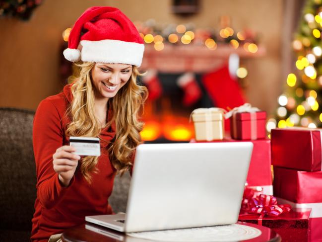 A happy woman buying Christmas presents online to complete her shopping list. Picture: iStock.