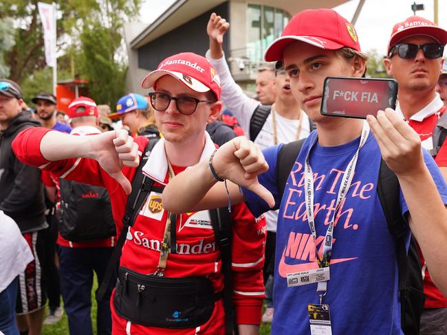 Motoring fans display their displeasure after the eleventh-hour cancellation of the Melbourne Grand Prix, March 13. Picture: AAP Image/Scott Barbour