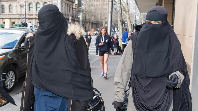 Two Muslim women leave the Melbourne Magistrate's Court. after refusing to stand for the magistrate. Picture: Paul Jeffers.