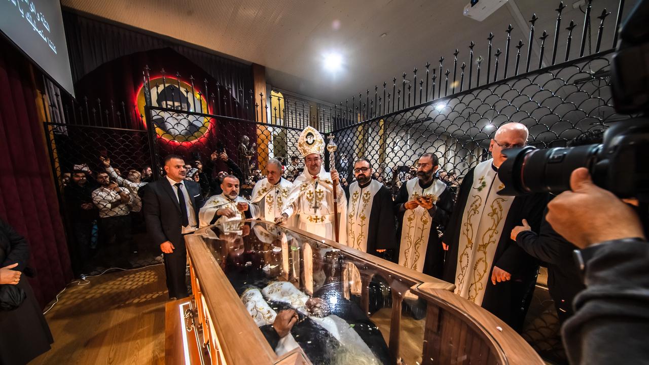 Bishop Antoine-Charbel Tarabay is joined with the St Charbel priests near the coffin. Picture: Images by Giovanni Portelli Photography