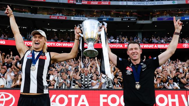 MELBOURNE, AUSTRALIA - SEPTEMBER 30: Darcy Moore of the Magpies and Craig McRae, Senior Coach of the Magpies celebrate with the premiership cup during the 2023 AFL Grand Final match between the Collingwood Magpies and the Brisbane Lions at the Melbourne Cricket Ground on September 30, 2023 in Melbourne, Australia. (Photo by Dylan Burns/AFL Photos via Getty Images)