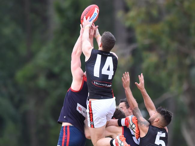 Tim Jones flies for a mark. Picture: Lawrence Pinder