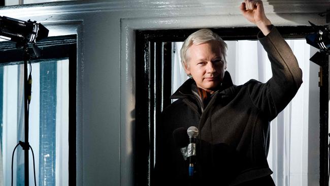 Julian Assange gestures as he addresses members of the media and supporters from the window of the Ecuadorian embassy in Knightsbridge in 2012. Picture: AFP.