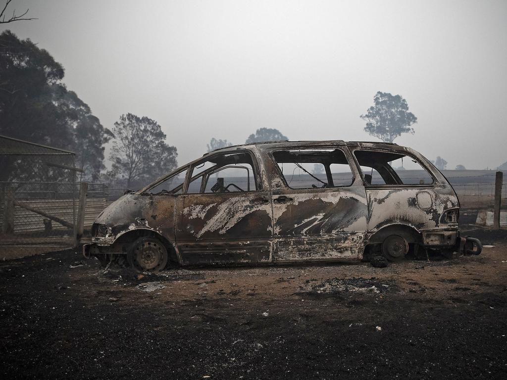 The morning after a devastating blaze destroyed homes and businesses in the small town of Cobargo. The town has been decimated by fire. A burnt out Tarago van at a destroyed property at Cobargo. Picture Gary Ramage