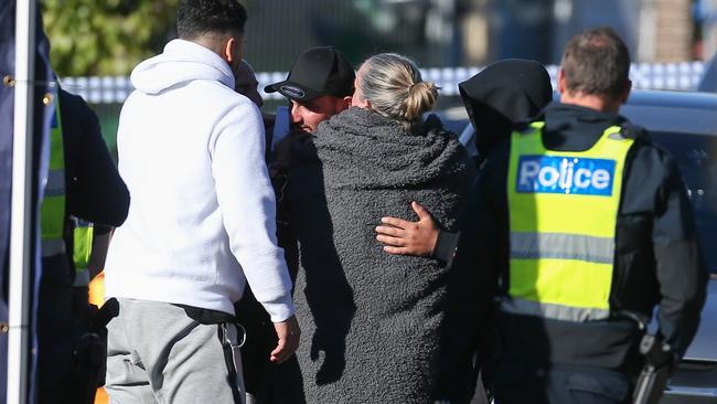 Loved ones embrace at the crime scene. Picture: Brendan Beckett