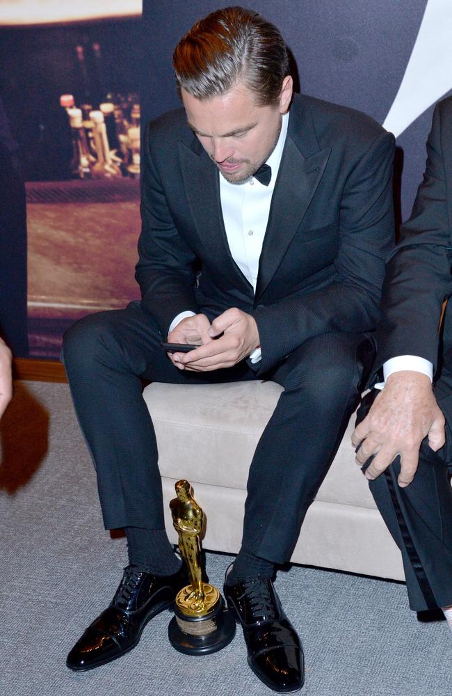 Phone in hand, Leonardo DiCaprio was the centre of attention (not that he cared) at the Vanity Fair post-Oscars party. Picture: Jeff Vespa/VF16/WireImage