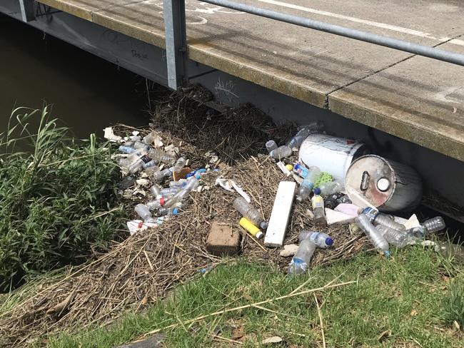 Discarded bottles and metal containers under a bridge in Reservoir. Picture: Snap Send Solve