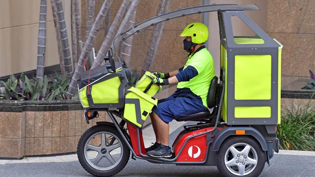 An Australia Post worker in Brisbane. Picture: NCA NewsWire / John Gass