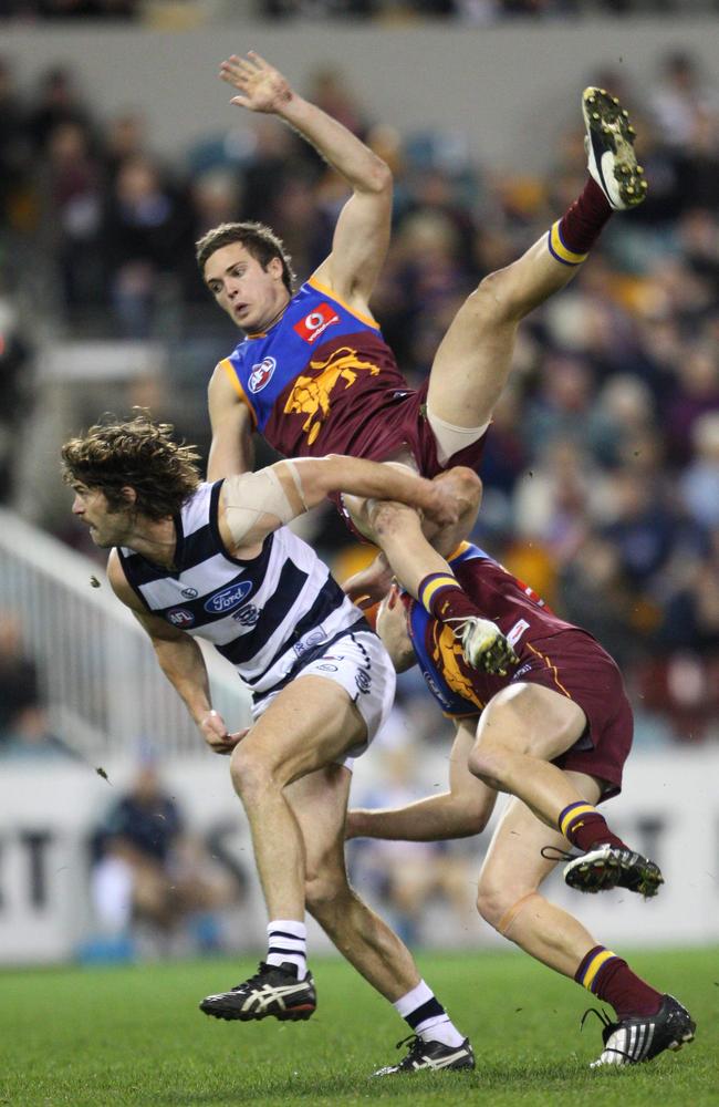 Matt Austin takes a ride over Geelong’s Max Rooke.