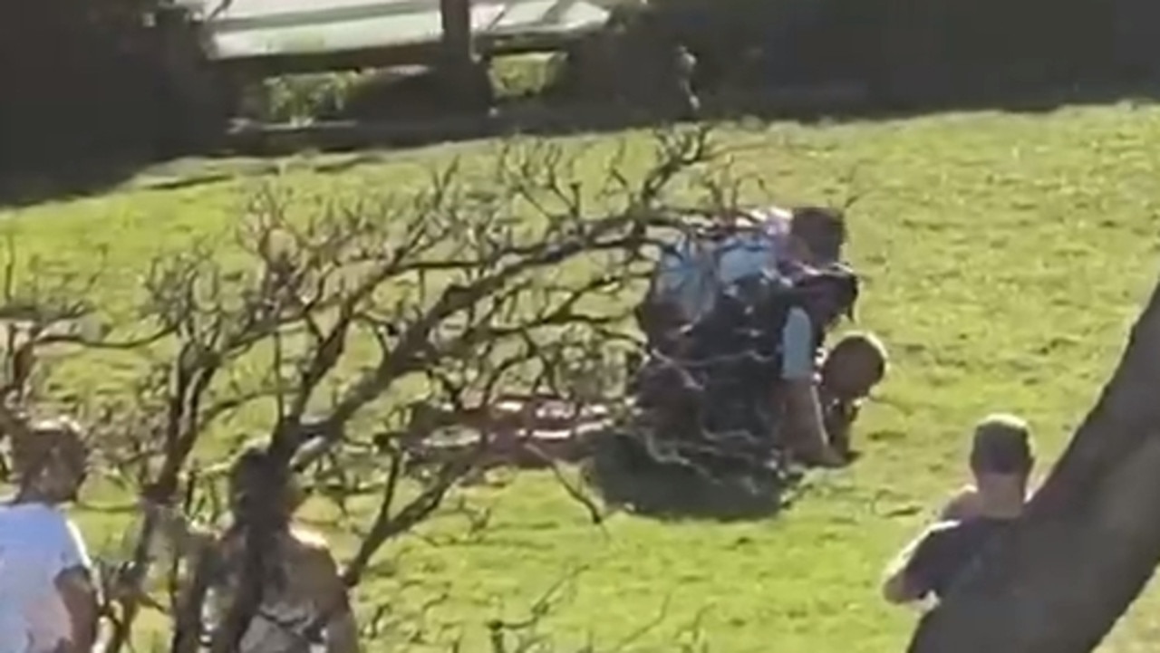 Dimitri Moskovich is pinned down by police at Ben Buckler reserve on Sunday. Picture: Supplied