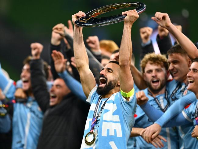 MELBOURNE, AUSTRALIA - MAY 31: Aziz Behich of the City holds aloft the A-League Men Championship trophy after winning the A-League Men Grand Final match between Melbourne City and Melbourne Victory at AAMI Park on May 31, 2025, in Melbourne, Australia. (Photo by Quinn Rooney/Getty Images)