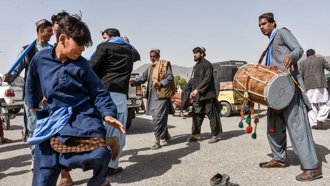 Afghans celebrate the patrial truce with dance in Kandahar on Saturday. Picture: AFP