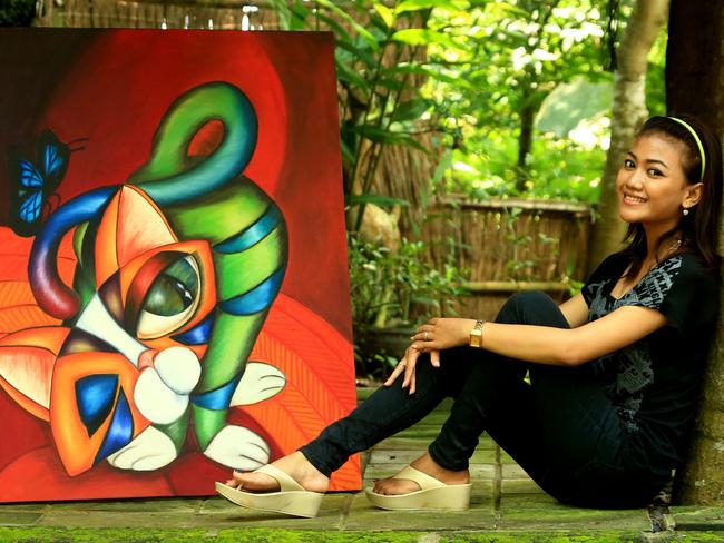 Alit with one of her paintings. Picture: Adam Taylor