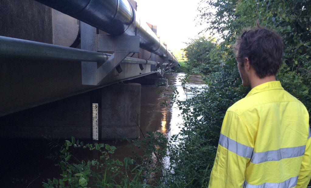 RISING RIVER: Gympie Regional Council worker Josh Hyam checks the rising Mary River at Kidd Bridge at a height of 8m at 6.30am on Friday. Picture: Frances Klein