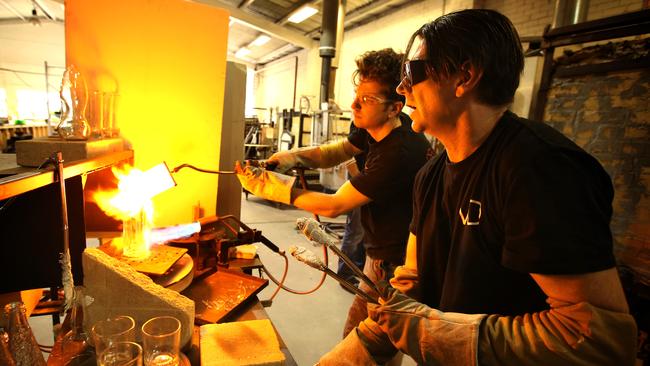 Glass designer Mark Douglass, right, with assistant Matthew Jovanovic, turns waste glass from the restaurant trade into useful objects at Upcycled Glass in Melbourne. Photo: Stuart McEvoy