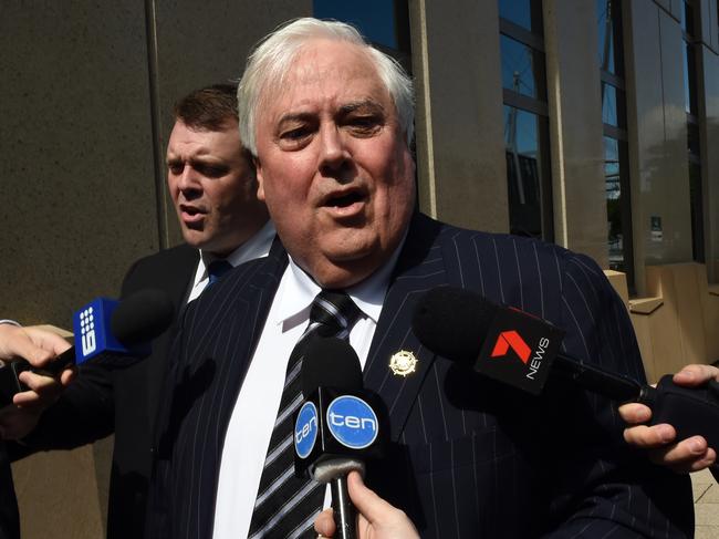 Businessman Clive Palmer, flanked by security guards, arrives at the Federal Court in Brisbane, Friday, Sept. 16, 2016. The former federal MP will continue to give evidence under oath about the demise of Queensland Nickel, which was put into liquidation earlier this year. (AAP Image/Dan Peled) NO ARCHIVING