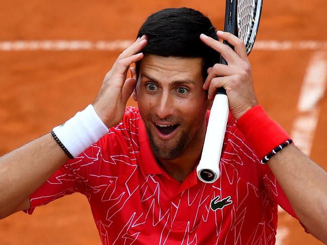 Serbia's Novak Djokovic reacts as he takes part in tennis match during a charity exhibition hosted by him, in Belgrade on June 12, 2020. - Novak Djokovic has also tested positive for coronavirus on June 23, 2020 along with Grigor Dimitrov, Borna Coric and Viktor Troicki, after taking part in an exhibition tennis tournament in the Balkans featuring world number one Novak Djokovic, raising questions over the sport's planned return in August. (Photo by Andrej ISAKOVIC / AFP)