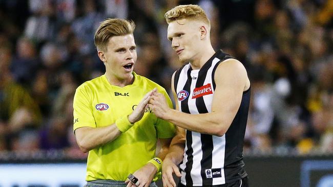 Adam Treloar enjoys a fist-bump with an umpire back in 2016. Picture: Colleen Petch.