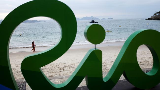 A couple walks along Copacabana beach ahead of the upcoming 2016 Summer Olympics in Rio de Janeiro, Brazil, Thursday, Aug. 4, 2016. The iconic Copacabana beach will be the starting point for the road cycling race, marathon swimming and triathlon competitions during the Olympics. (AP Photo/David Goldman)