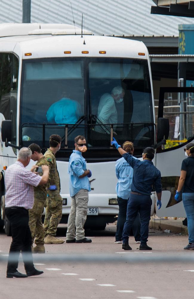 Multiple government agencies gather beside buses to take Australian evacuees from the Diamond Princess after they arrived in Darwin. Picture: AAP