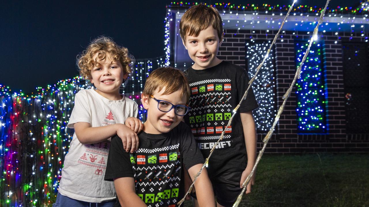 Brothers (from left) Finley, Alfie and Harvey Rasmussen with the Christmas light display at their family home in Wyreema, Monday, December 13, 2021. Picture: Kevin Farmer