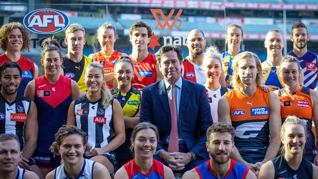 Outgoing AFL CEO poses with AFL and AFLW players. Picture: Mark Stewart