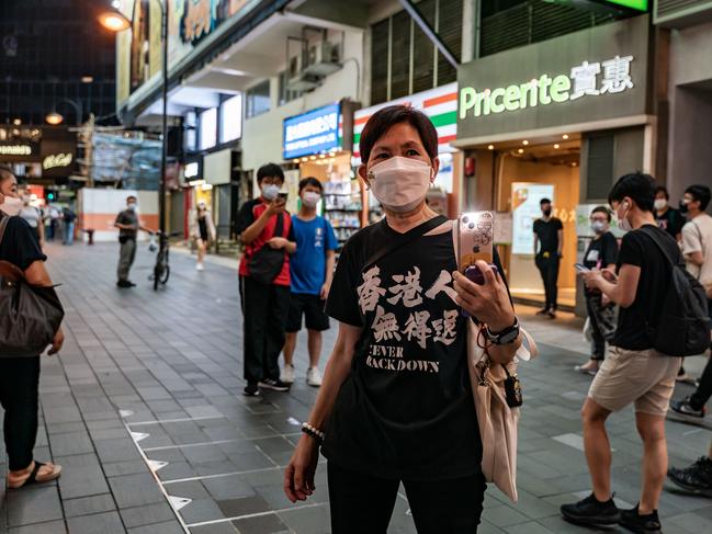 A woman holds an illuminated cell phone near Victoria Park, the traditional site of the annual Tiananmen candlelight vigil in Hong Kong, China. Picture: Anthony Kwan/Getty Images