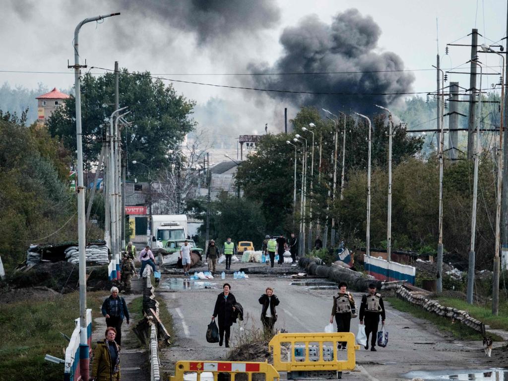 Women evacuating with belongings in the frontline city of Kupiansk. Picture: AFP