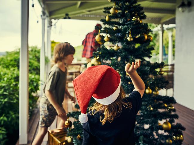 Cropped shot of kids decorating the Christmas tree