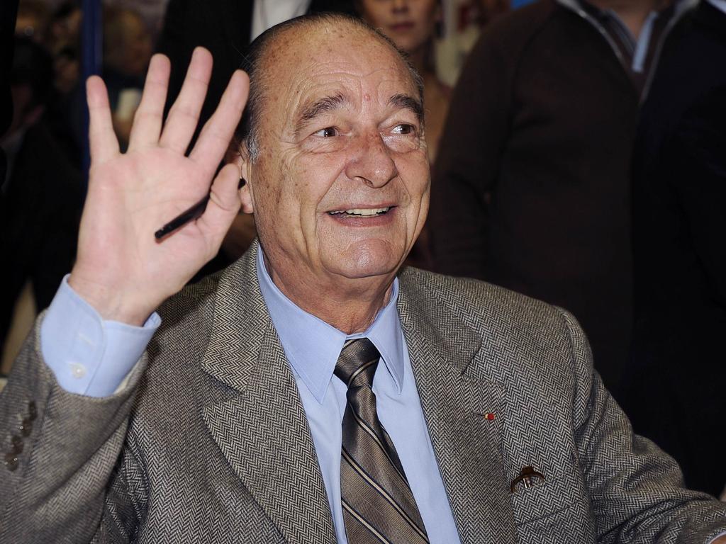 Former French President Jacques Chirac waves as he signs copies of his book 'Every Step Should Be a Goal' during Brive-la-Gaillarde book fair in southern France in 2009.