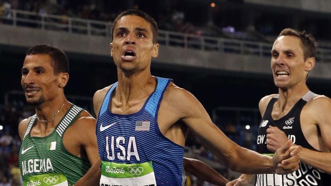 USA's Matt Centrowitz crosses the finish line ahead of silver medallist Taoufik Makhloufi  of Algeria (left) and bronze medallist Nick Willis of New Zealand in the Men's 1500m final at the 2016 Rio Olympic Games.