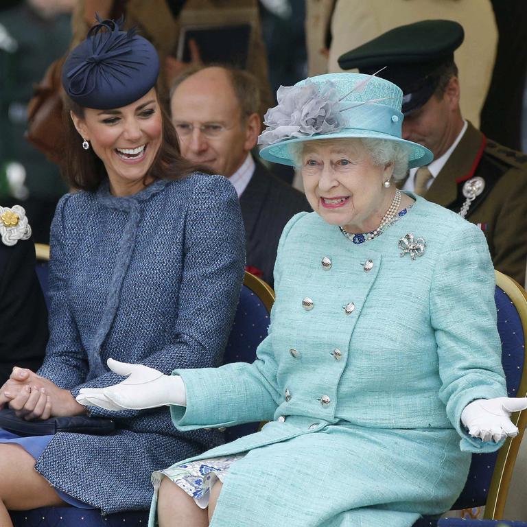 2012: Catherine, Duchess of Cambridge laughs as the Queen gestures while watching a children’s sports event on their visit to Vernon Park in Nottingham, central England, on June 13, 2012. Picture: Phil Noble/AFP