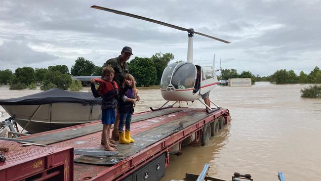 The Wilson family is evacuated from Tirranna Roadhouse. The family was able to take one dog with them.