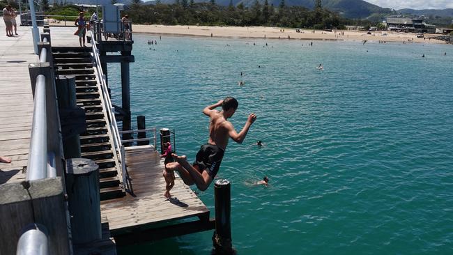 Jayden Coombes from Arrawarra takes the plunge at the jetty – a key recreation spot for locals and visitors. Picture: Chris Knight