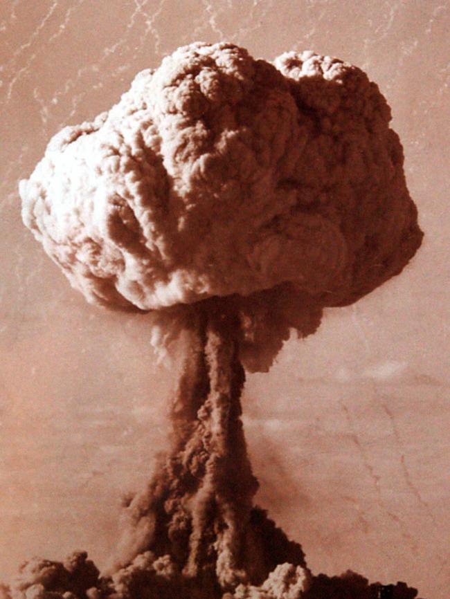 Detonation of the atomic bomb at the nuclear test site at Maralinga in 1956 photo. The diagonal lines going through the cloud bloom are small rockets fired to collect samples.