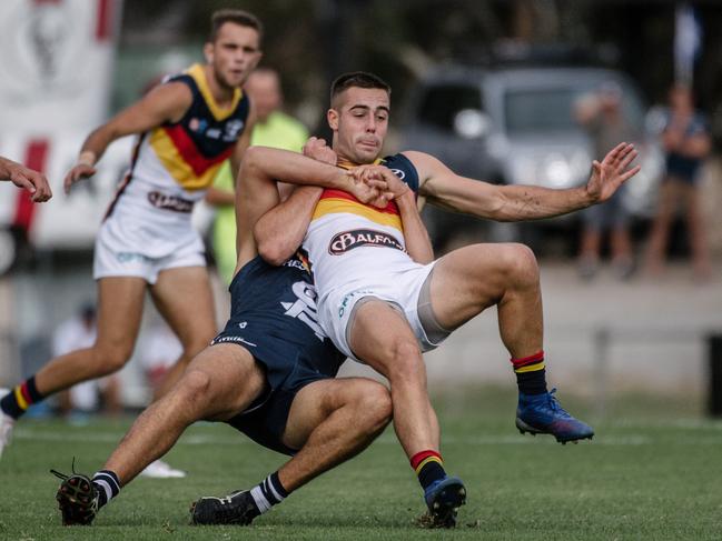 Adelaide player Myles Poholke being tackled during the South Adelaide versus Adelaide at Noarlunga Oval on Saturday, April 20, 2019. (AAP Image/ Morgan Sette)