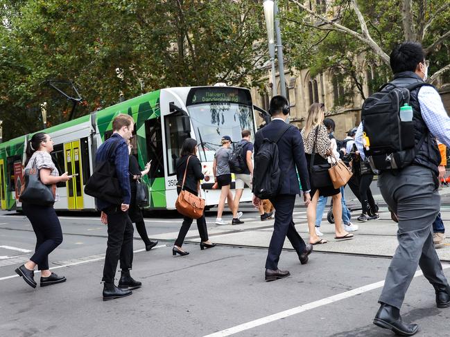 City workers stream from Flinders Street Station into the city on the first day back to the office as Covid-19 restrictions are lifted. Picture : Ian Currie