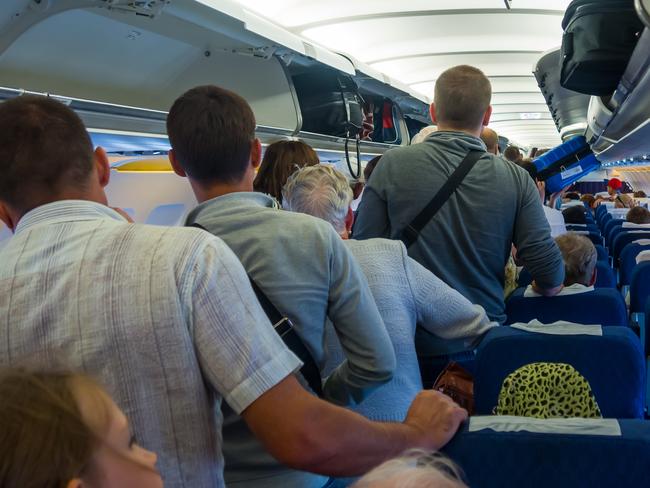 People waiting to get out of the plane