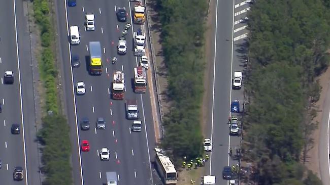 Multiple people have been taken to hospital after a collision between a bus and semi-trailer on the M1. Picture: Supplied / Channel 9