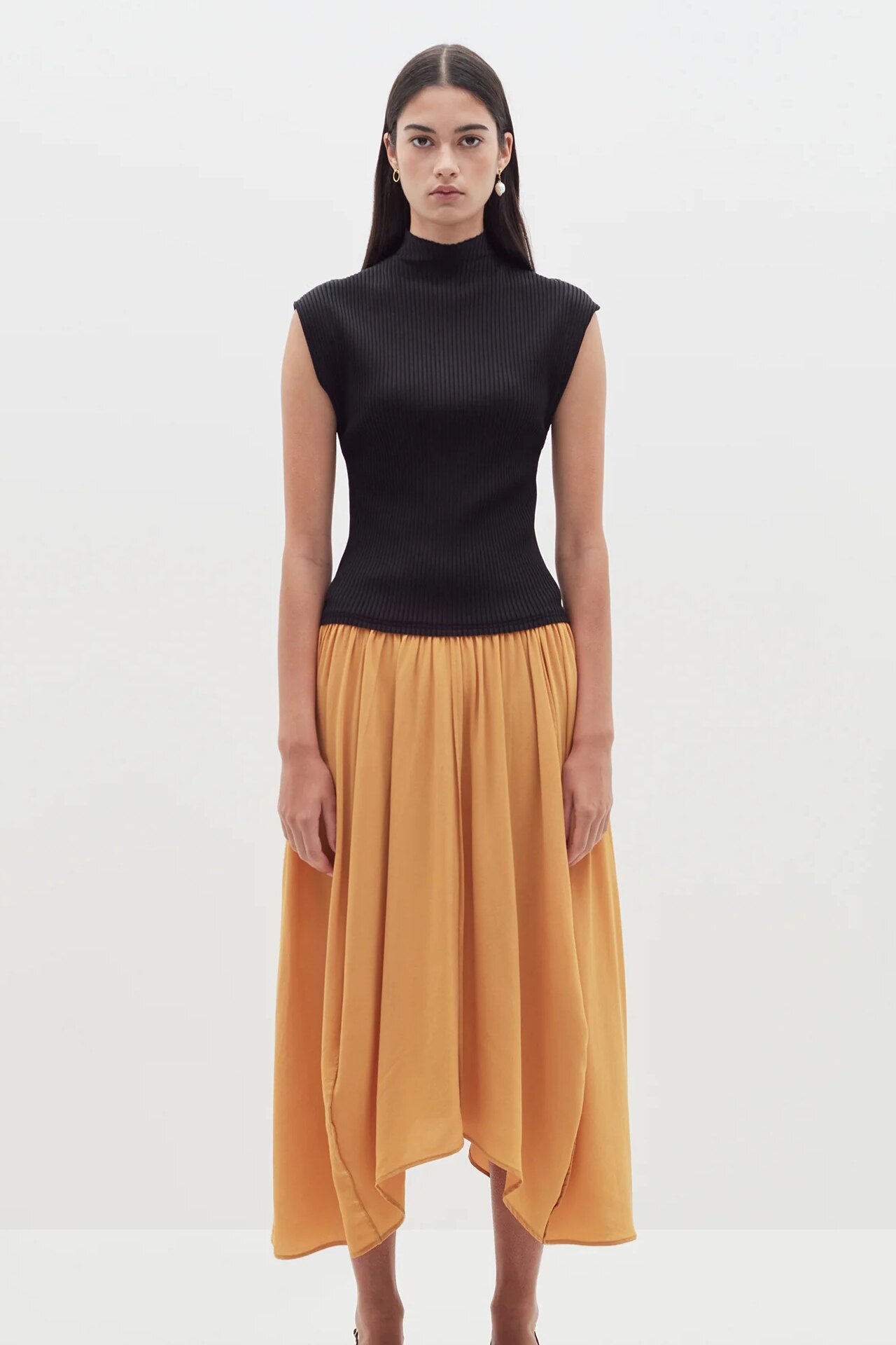 <p>&ldquo;I love a two-tone drop-waist dress, and this black and ochre design from Bassike fits the bill perfectly. The high-neck accentuates the elegance, while the fluttery hem on the skirt adds movement. One to wear day and night.&rdquo; <i>&mdash;Gladys Lai, content editor</i></p><p><b>SHOP NOW:</b> Raised neck rib contrast dress, $370 from <a href="https://www.bassike.com/collections/women-dresses/products/raised-neck-rib-contrast-dress-pc23wfd123-black-ochre" target="_blank" rel="nofollow noopener"><b>Bassike</b></a></p>