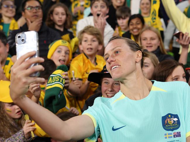 BRISBANE, AUSTRALIA - AUGUST 19: Emily Van-Egmond of Australia takes a selfie with fans after the FIFA Women's World Cup Australia & New Zealand 2023 Third Place Match match between Sweden and Australia at Brisbane Stadium on August 19, 2023 in Brisbane, Australia. (Photo by Cameron Spencer/Getty Images)