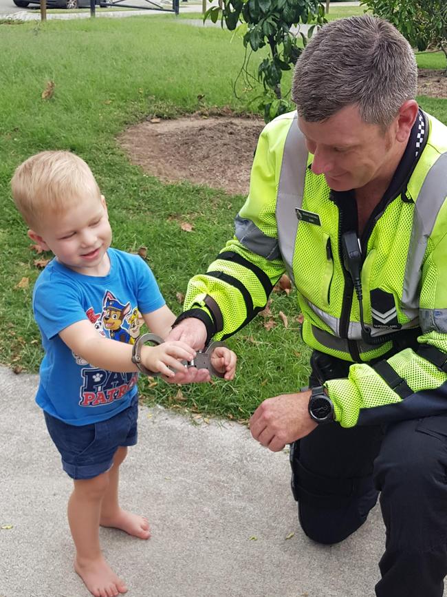 A police officer plays with Hamilton during his birthday party.